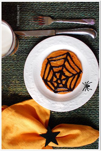 spooky pumpkin pancakes with black cinnmon syrup