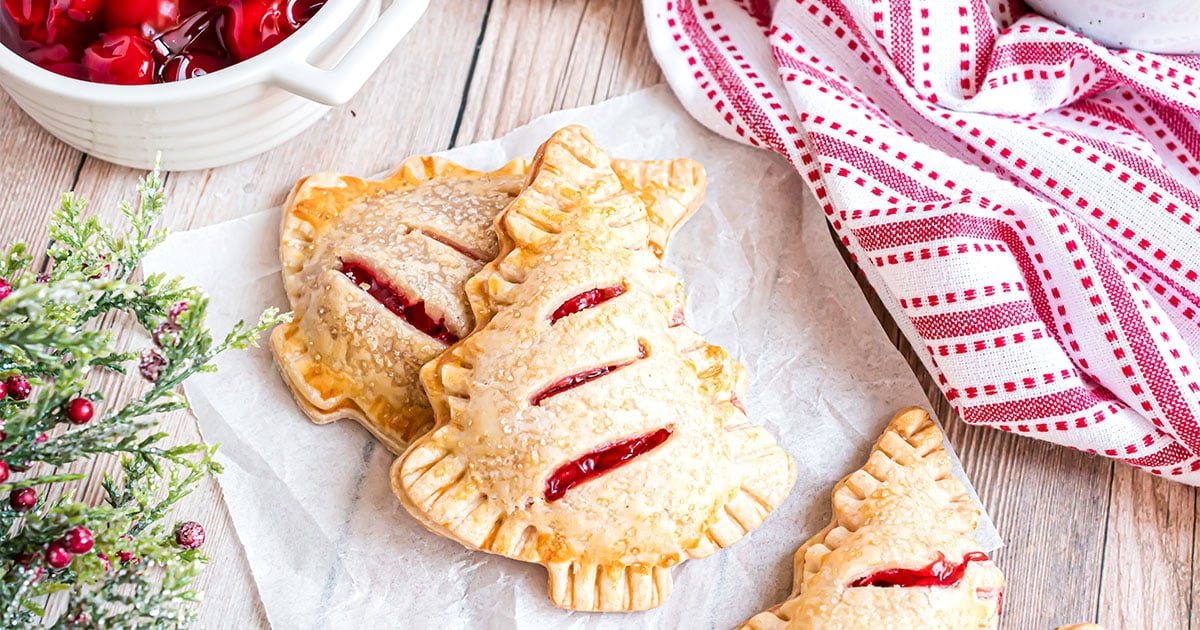 Holiday Tree Cherry Hand Pies on a counter with a red and white towel
