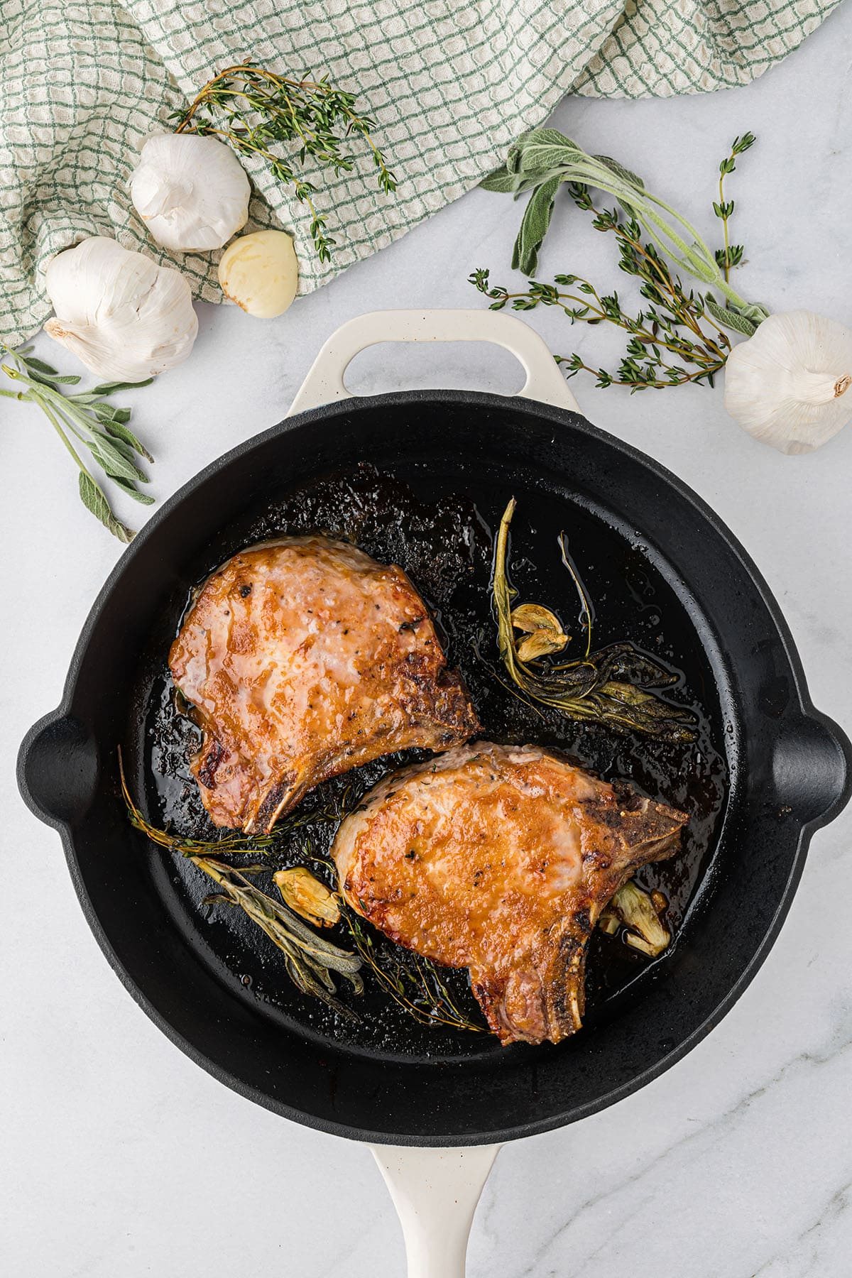 glazed pork chops in a cast iron skillet