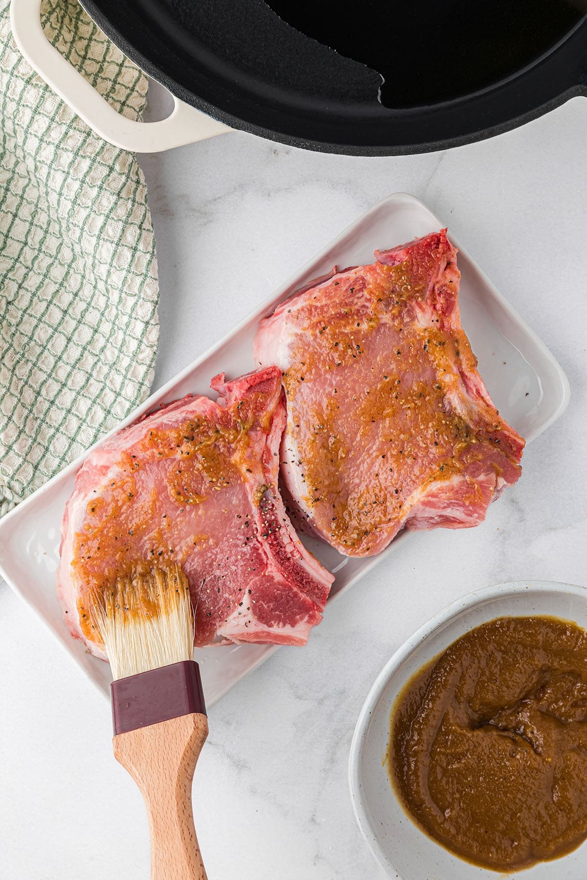 apple butter glaze being brushed on pork chops