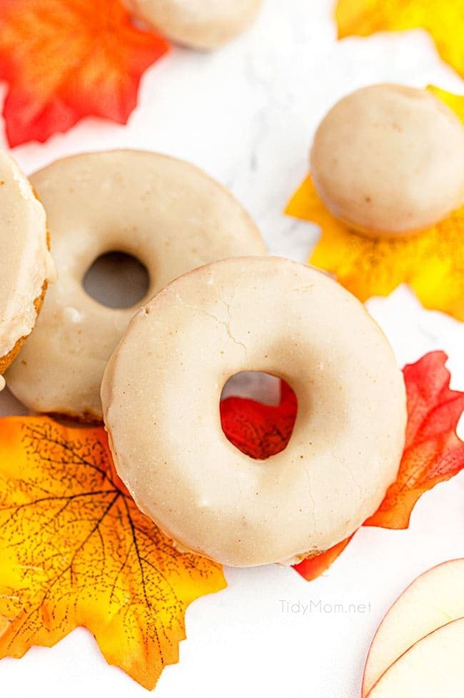 glazed apple cider donuts with colorful fall leaves
