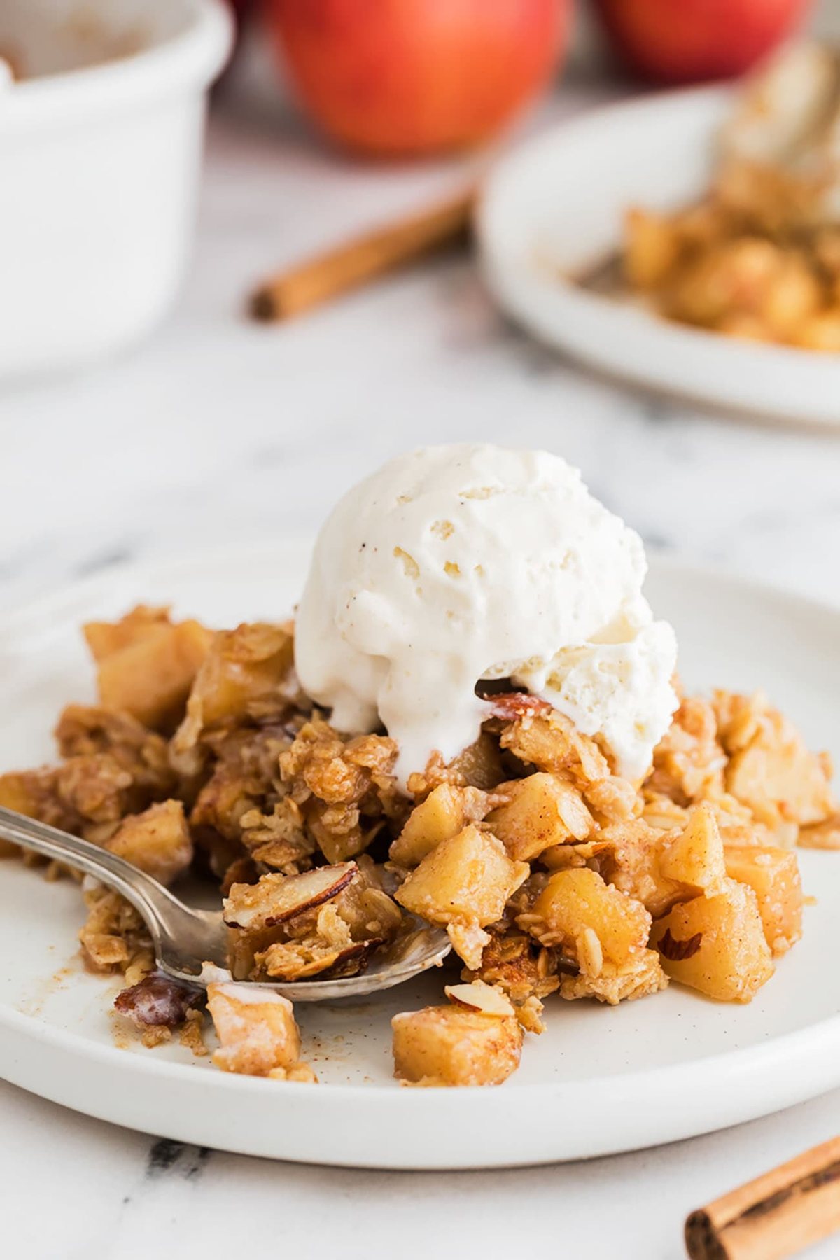 apple crumble on a plate with vanilla ice cream