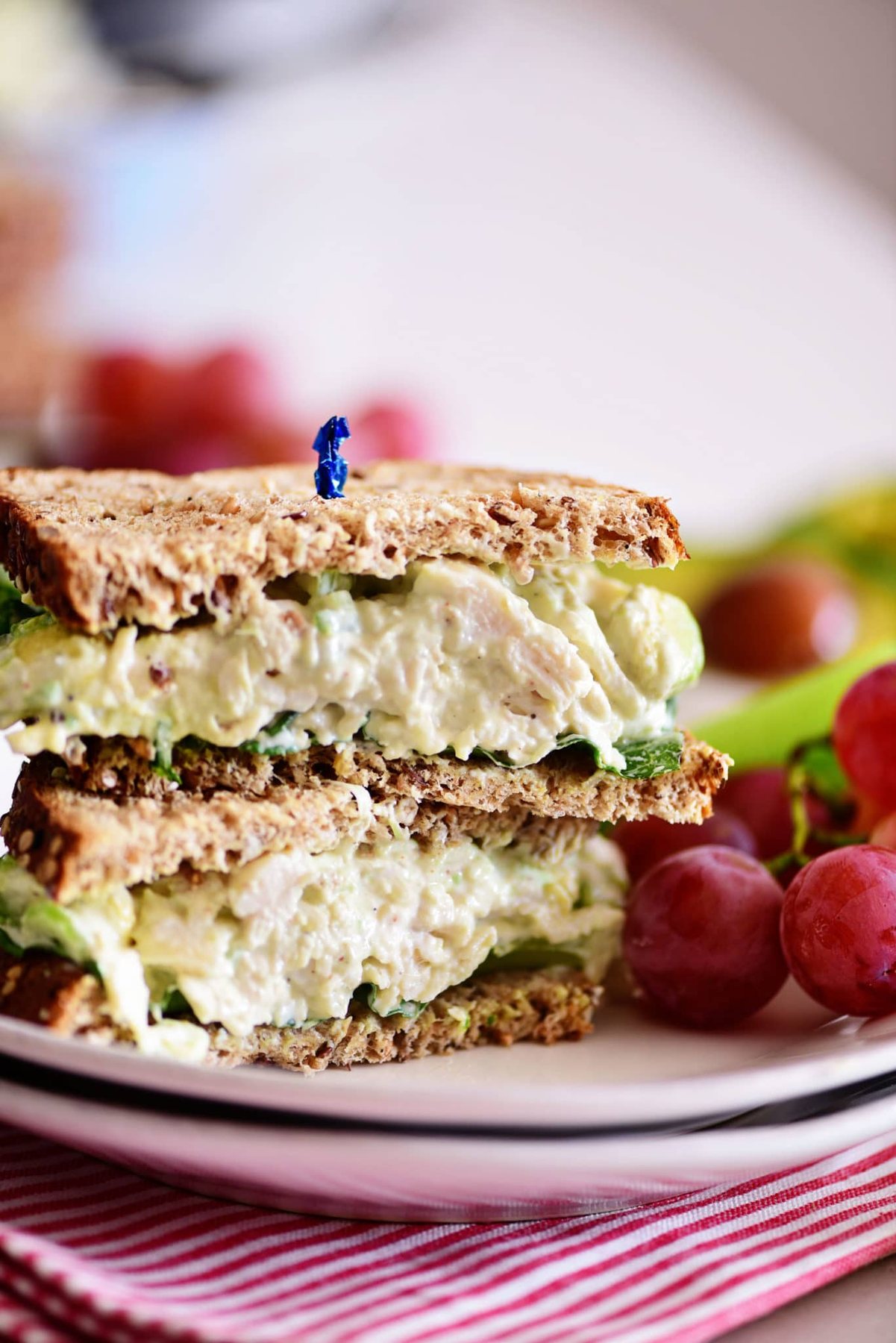 avocado chicken salad sandwich cut in half and stacked