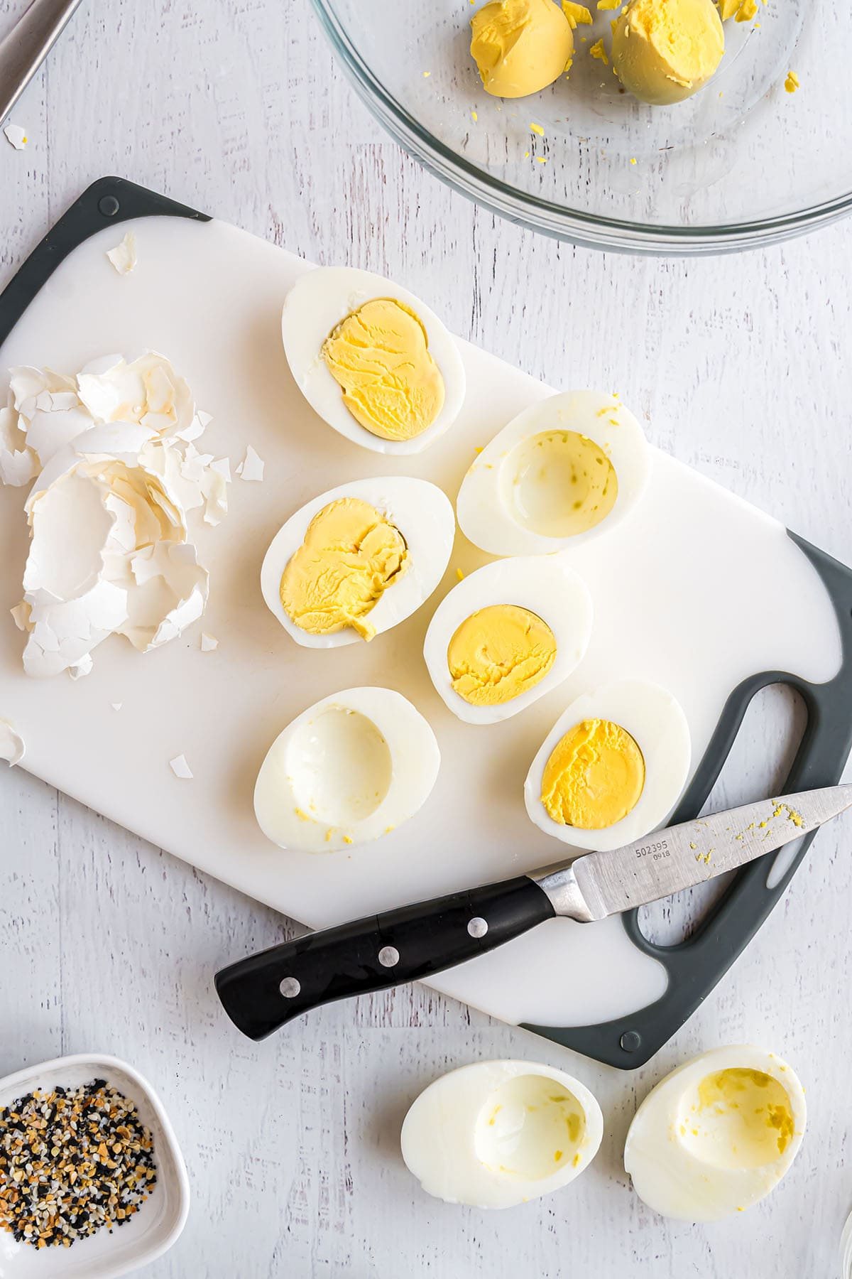 hard boiled eggs cut in half on a cutting board
