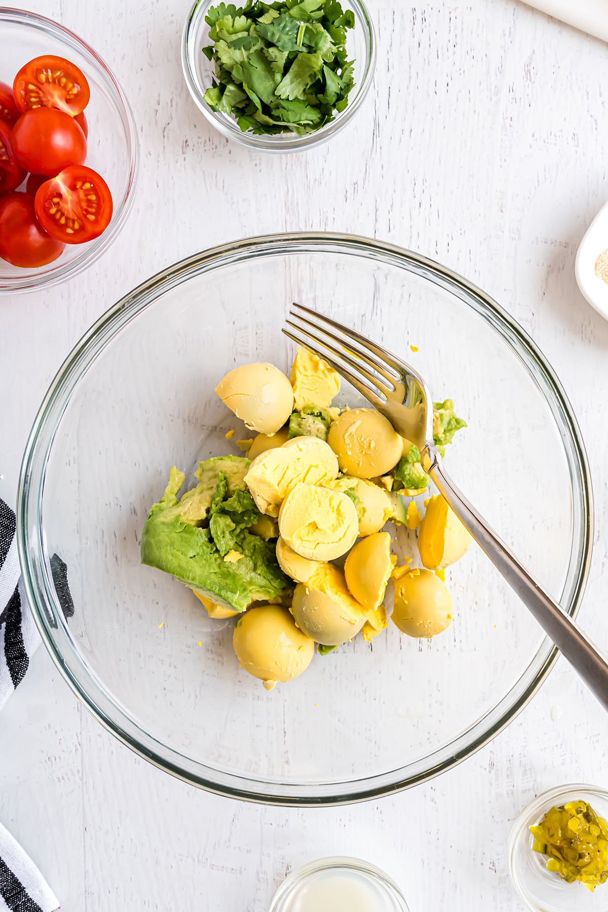 avocado deviled egg filling in a glass mixing bowl
