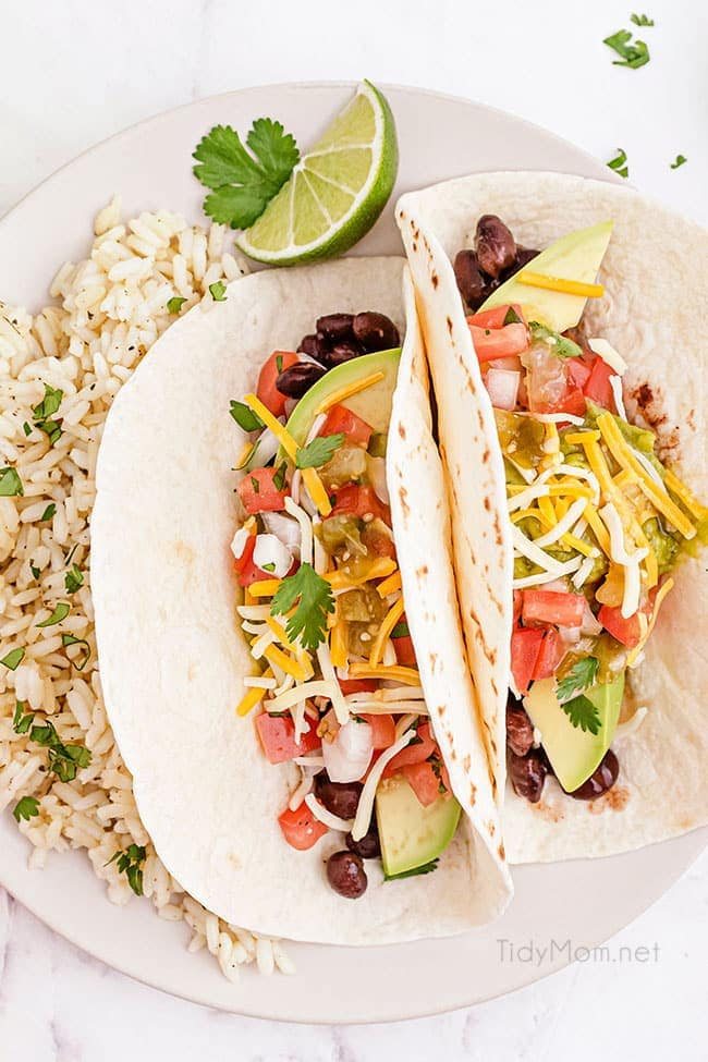 Two avocado tacos with a side of lime rice