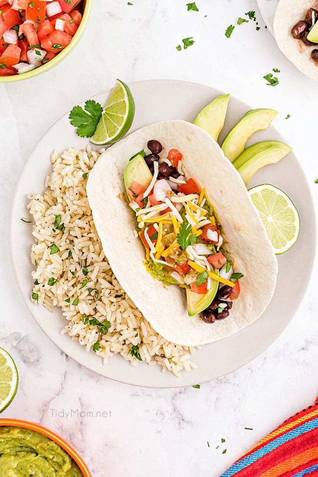avocado taco with a side of lime rice on a plate
