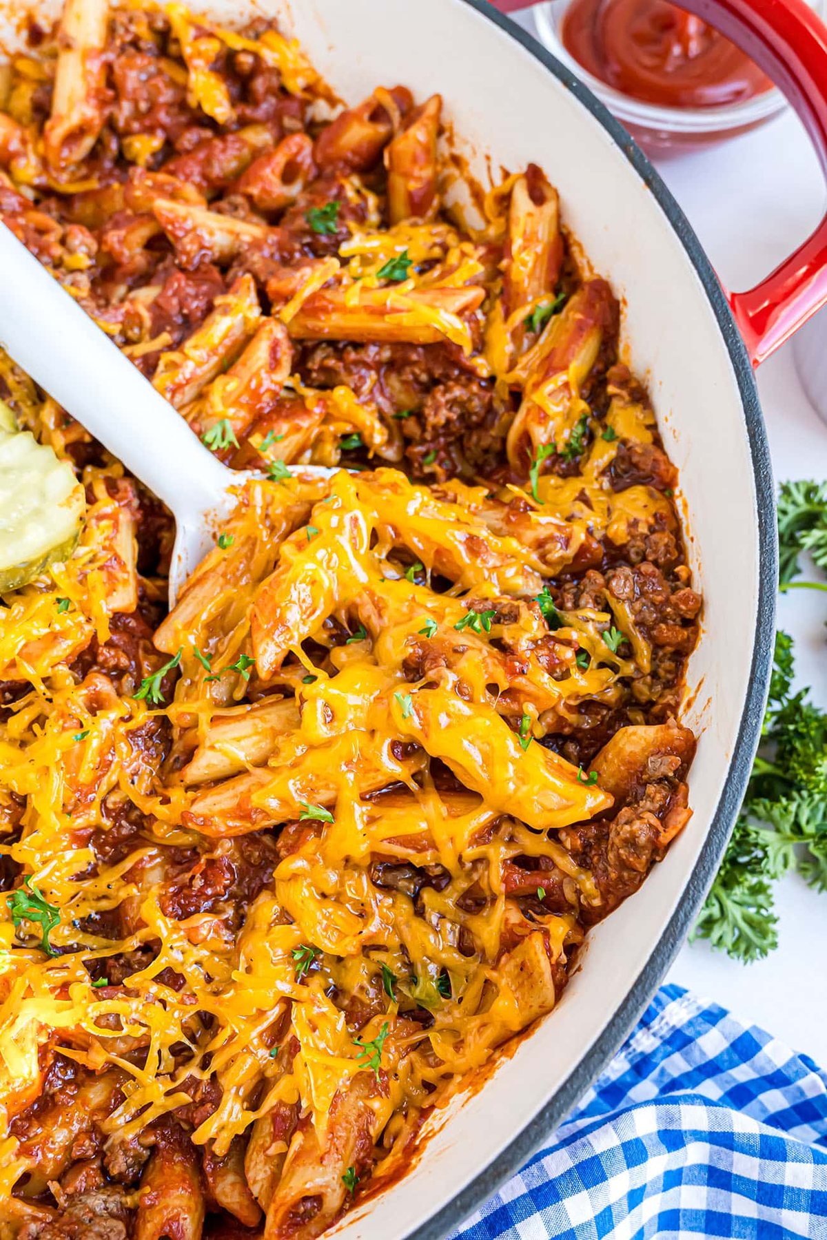 Close-up of Bacon Cheeseburger Pasta Skillet with melted cheddar and crispy bacon on top.