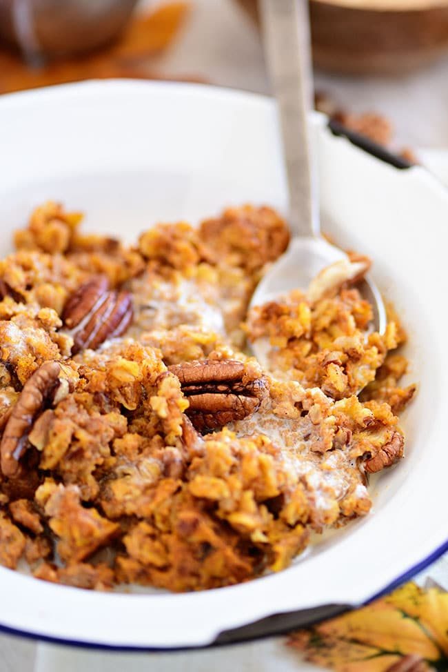 baked pumpkin oatmeal in a bowl with a spoon