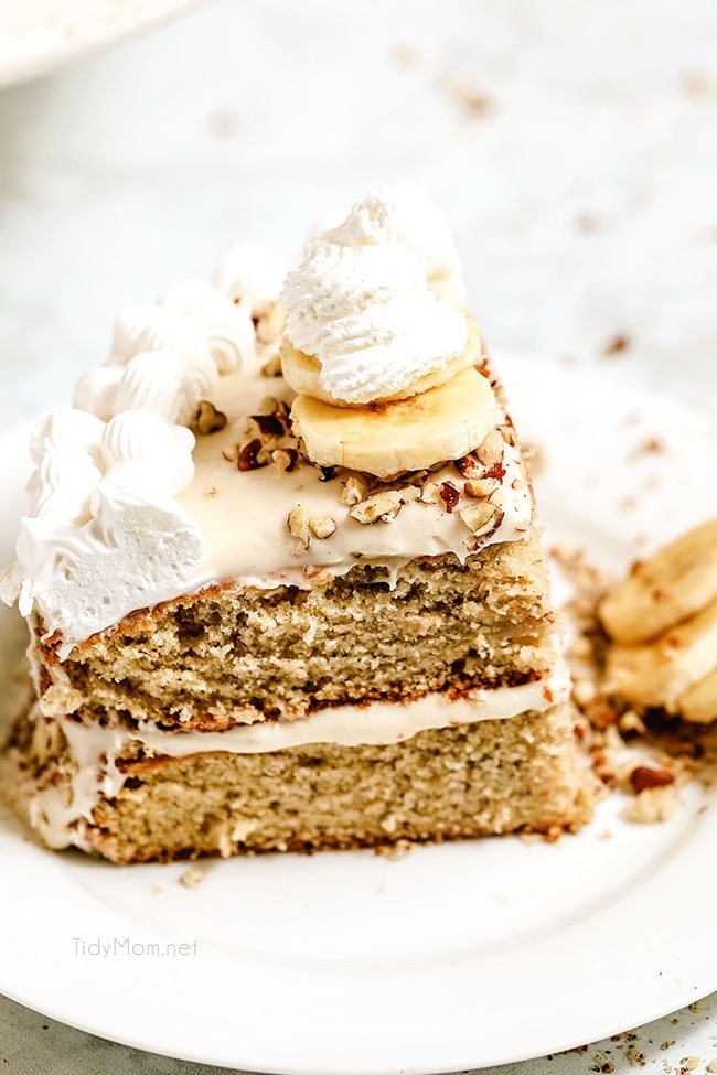 a slice of banana cake on a plate with banana slices on top