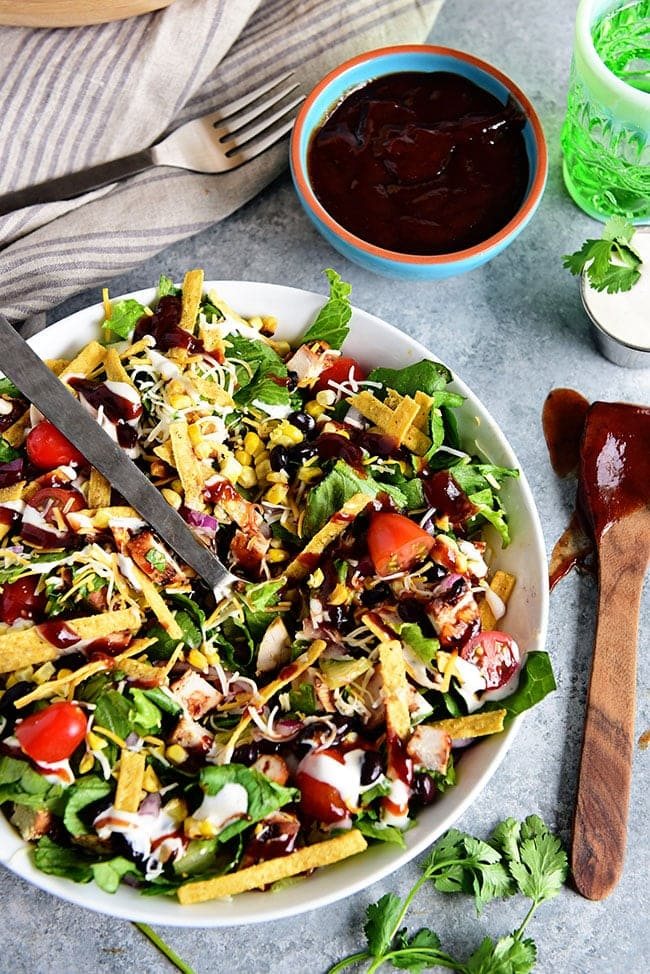 This BBQ Chicken Salad is super easy, can even be made with leftovers and it's off the hook delicious! Grilled corn and lime crema really make it sing! If you were a fan of Panera's BBQ Chicken Salad, you're going to love this copycat salad you can make in 15 minutes or less at home! Print the full recipe at cetcu.com