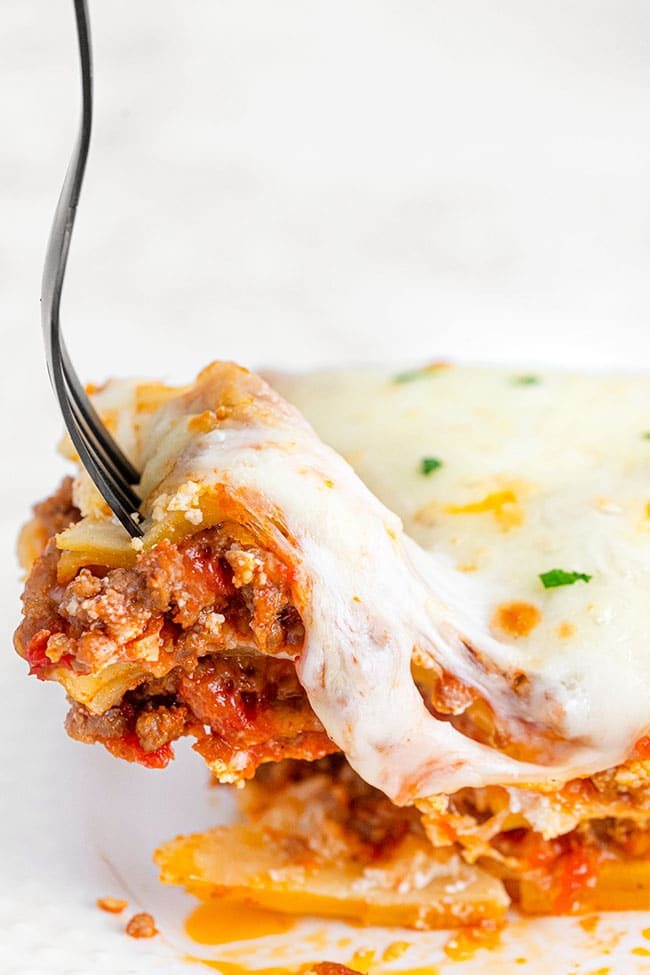 A bite of homemade lasagna on a fork