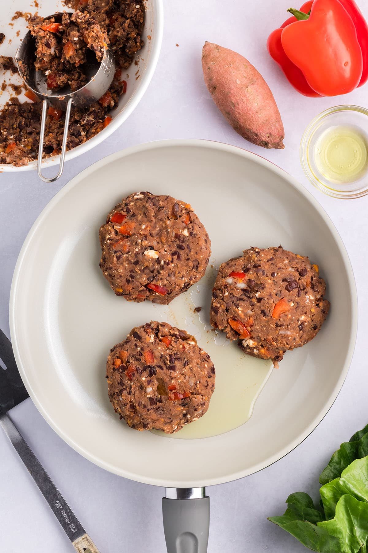 cooking black bean burger patties in a skillet