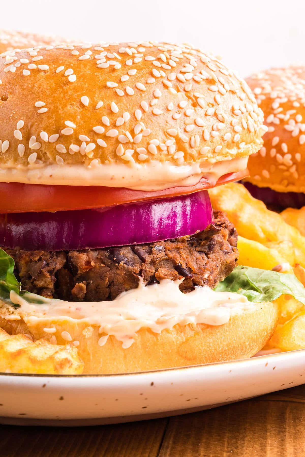 close up of a black bean burger on a sesame seed bun