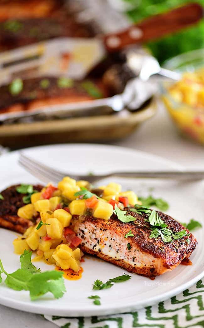 blackened salmon with mango salsa on a white plate
