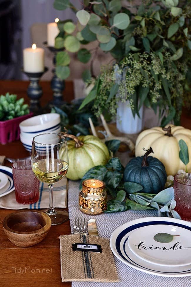 Seasonal Simplicity — Blue and Green Fall Tablescape with simple eucalyptus and pumpkins fall centerpiece . Get all the details along with 20+ Fall Home Tours at cetcu.com