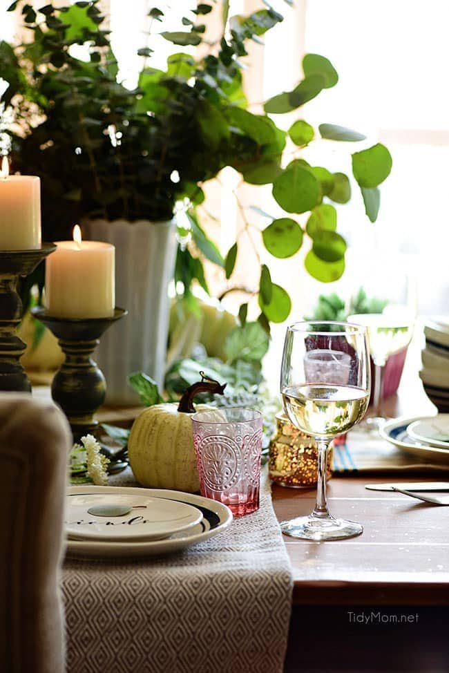 Set table with light candles: Seasonal Simplicity — Blue and Green Fall Tablescape with simple eucalyptus and pumpkins fall centerpiece . Get all the details along with 20+ Fall Home Tours at cetcu.com