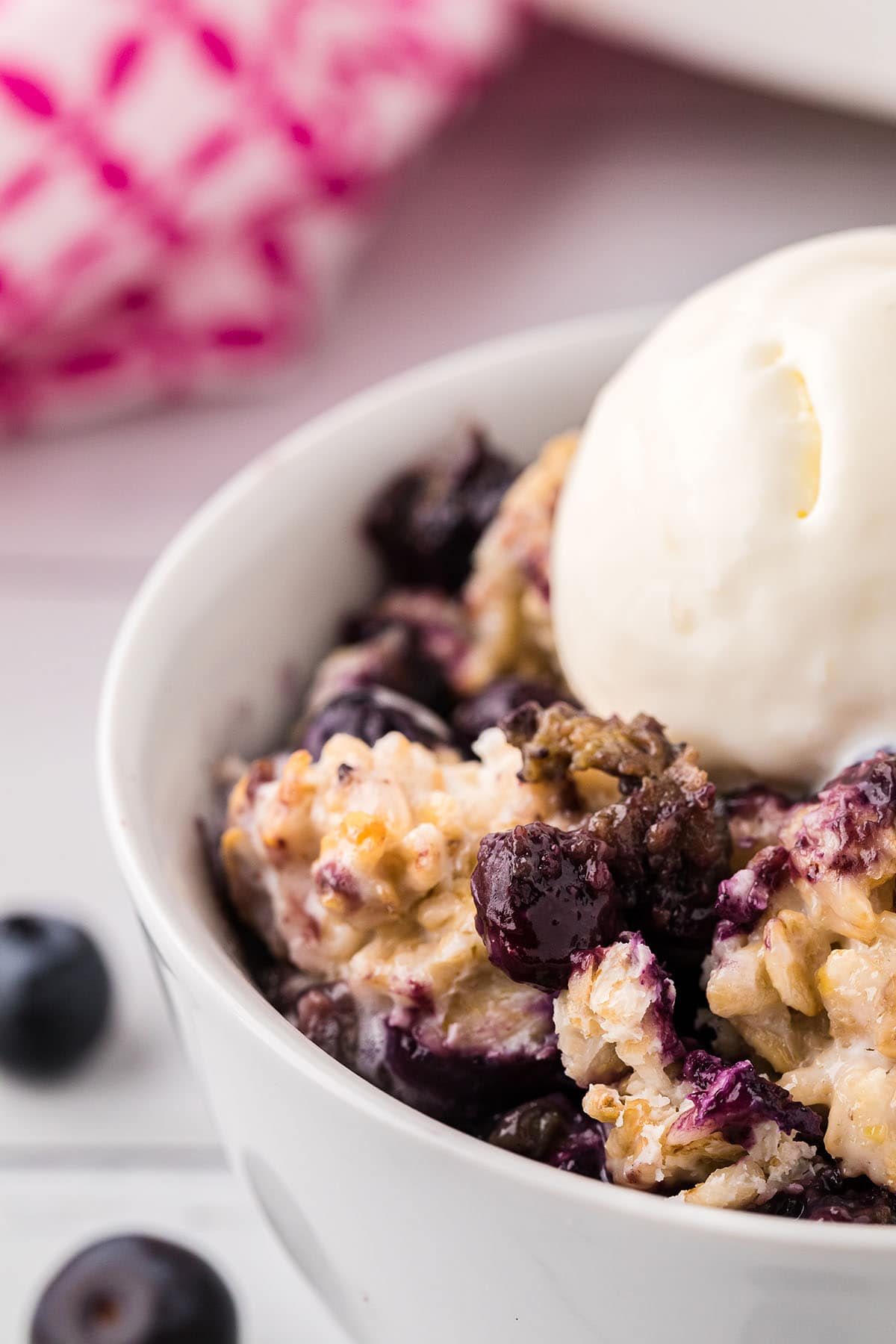 bowl of blueberry crisp with ice cream