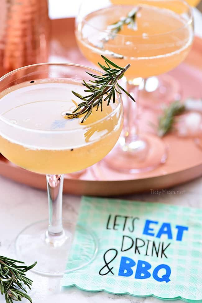 Bourbon Sour with smoked rosemary sprig in coupe glass