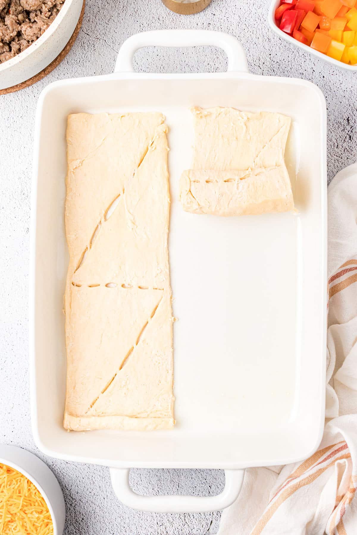 crescent roll dough in the bottom of a baking dish