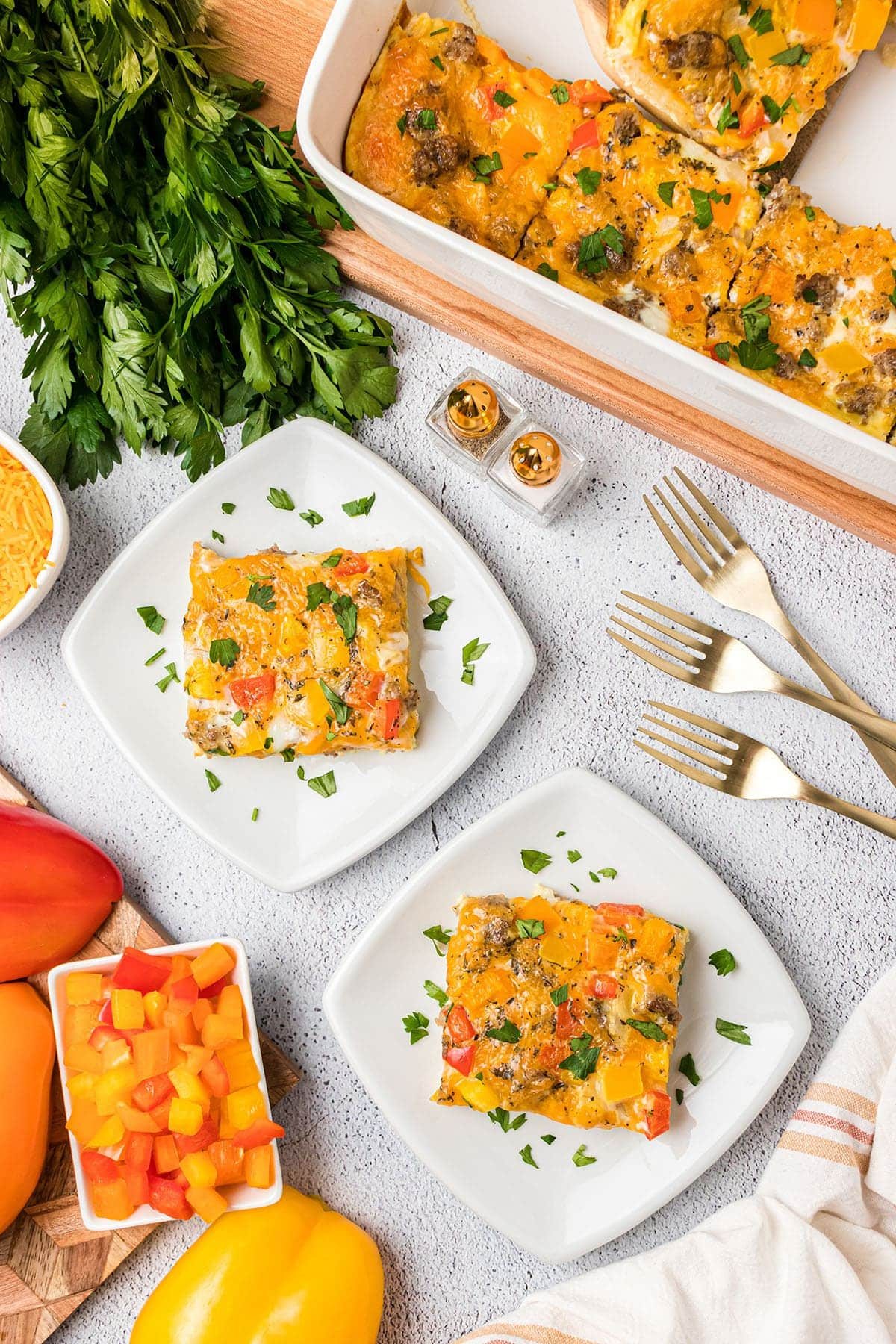 two plates and forks with a serving of breakfast casserole