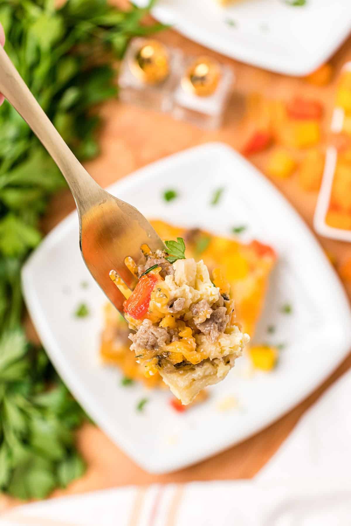 bite of breakfast casserole on a gold fork