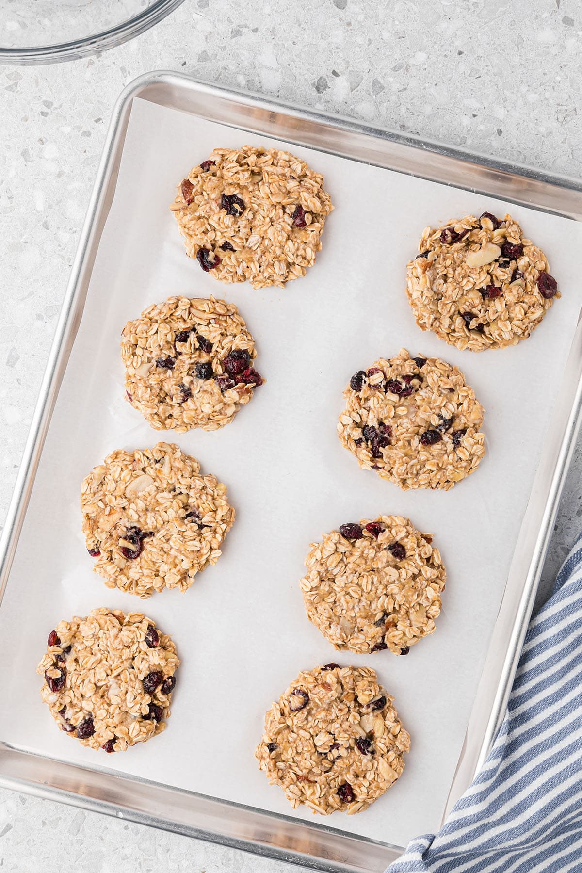 raw cookies on a baking sheet lined with parchement paper