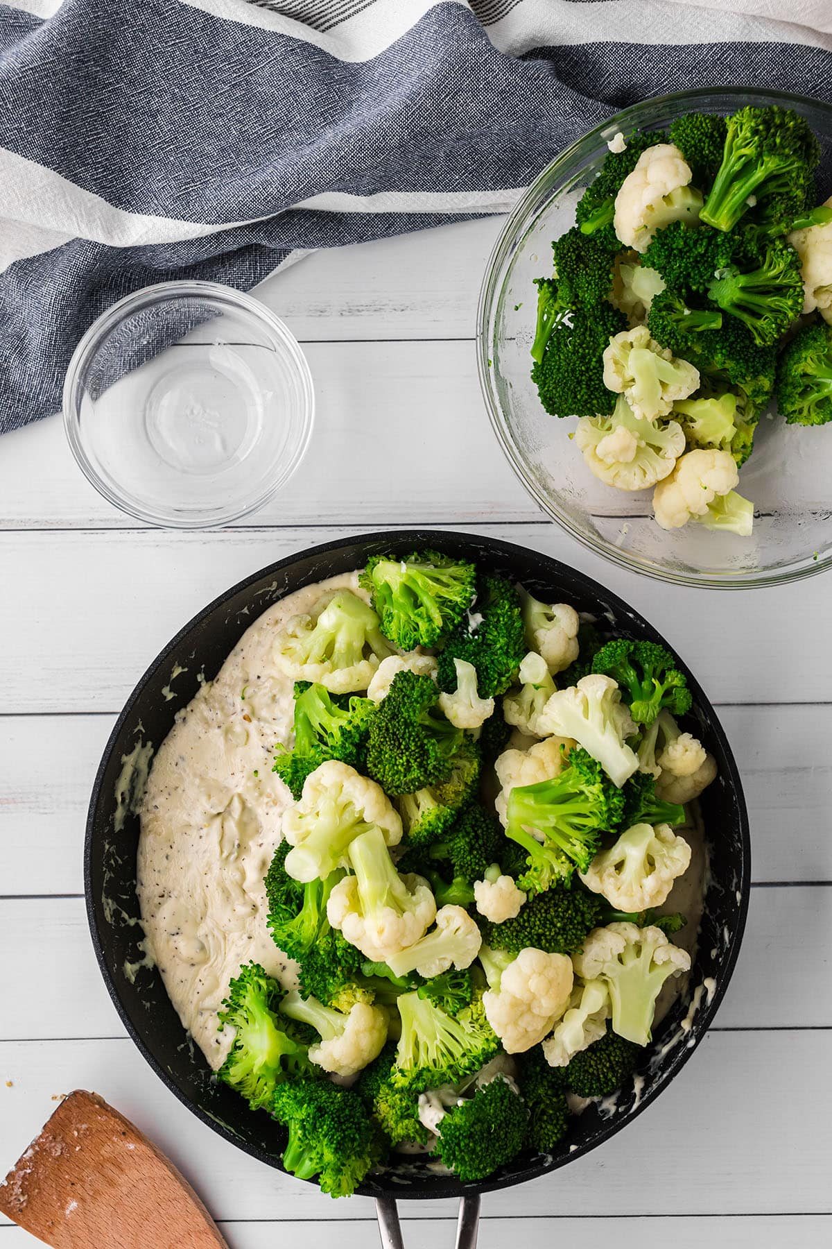 broccoli and cauliflower in a skillet with cheese