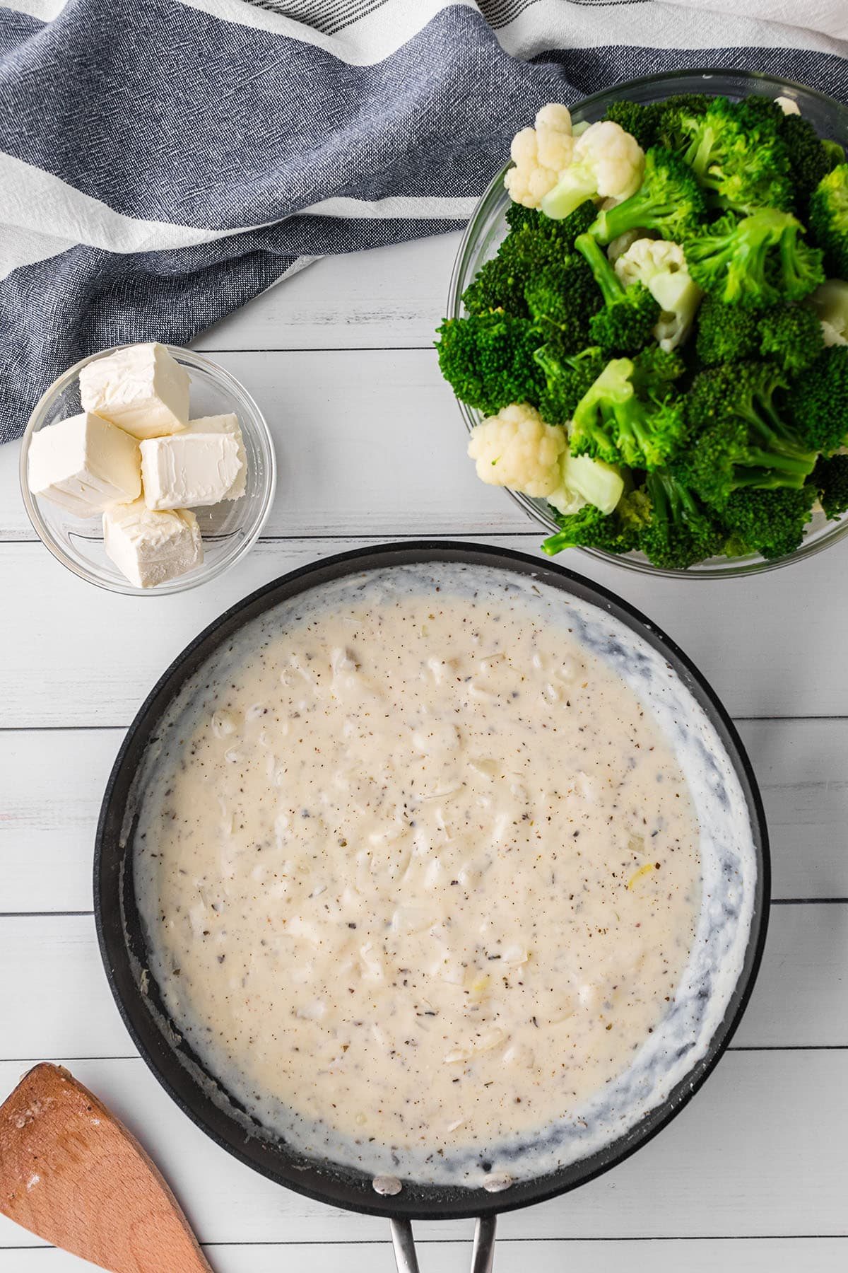 white sauce in skillet for Cheesy Broccoli Cauliflower Casserole