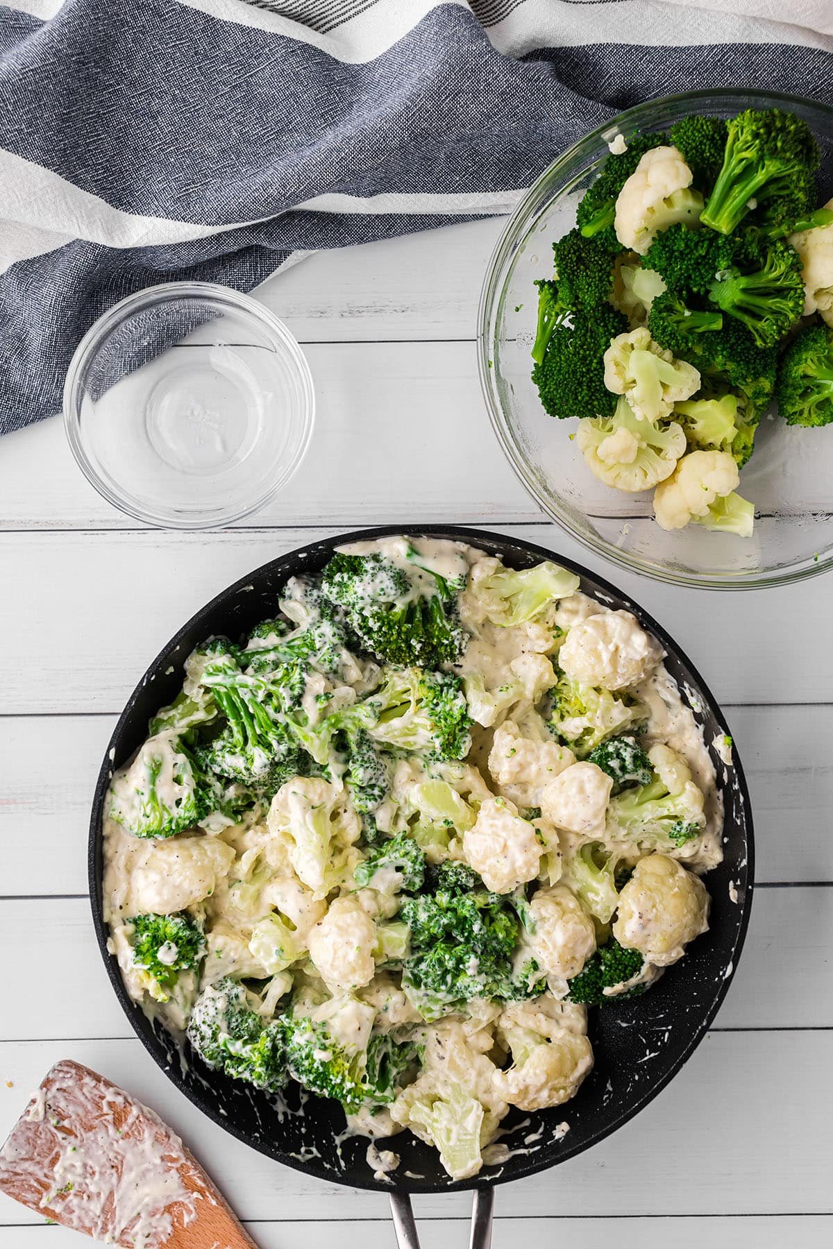 cheese sauce with broccoli and cauliflower in a skillet