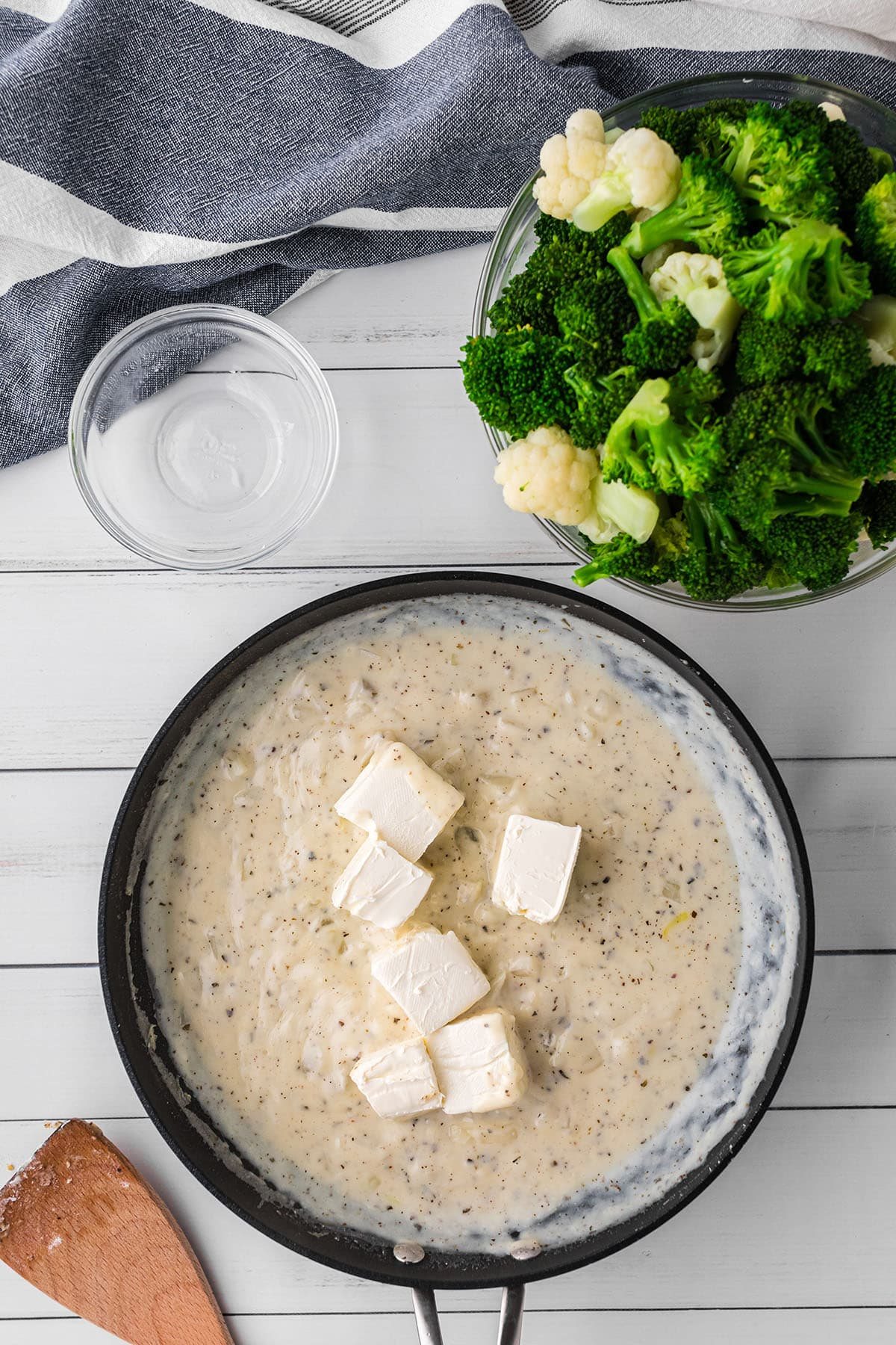 adding cream cheese to white sauce for Cheesy Broccoli Cauliflower Casserole