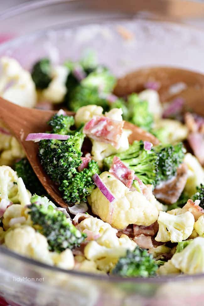 Broccoli Cauliflower Salad on wooden spoon