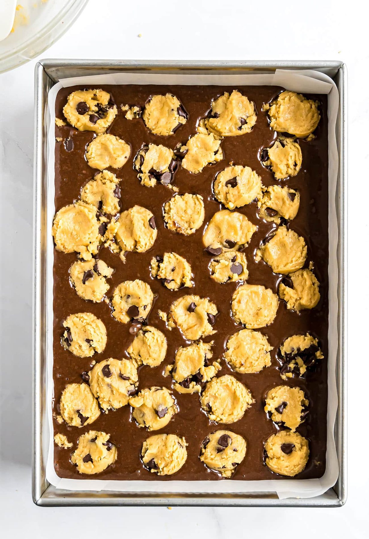 brownie cookie bars in a pan and ready for the oven