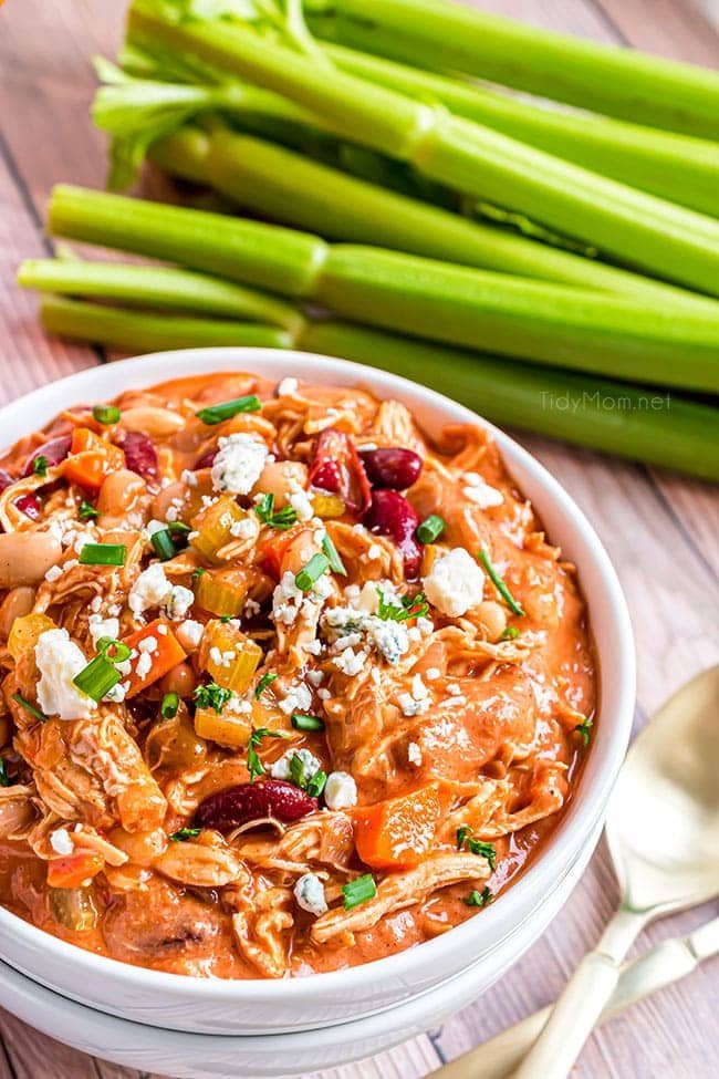 buffalo chicken chili in a white bowl and celery in background