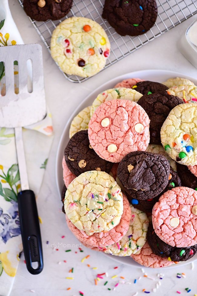 chocolate, vanilla and strawberry cookies stacked on plate