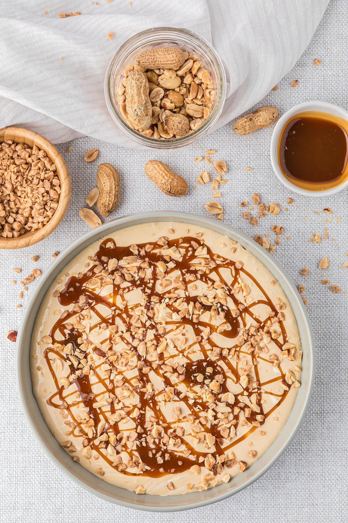 dessert dip with caramel topping and chopped peanuts