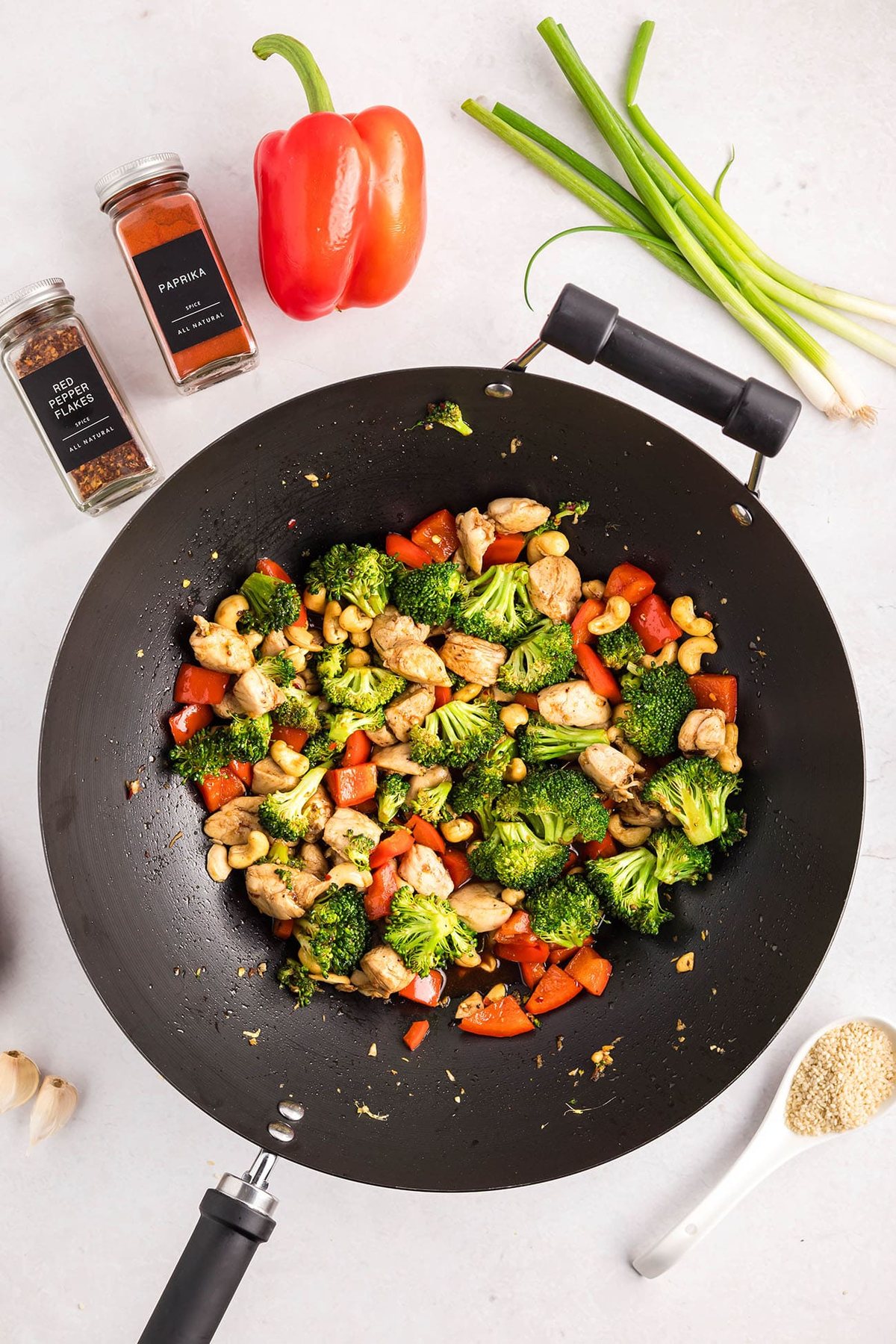 Cashew Chicken Stir Fry cooking in a wok with chicken, broccoli, red peppers, and cashews — step-by-step process from start to finish.