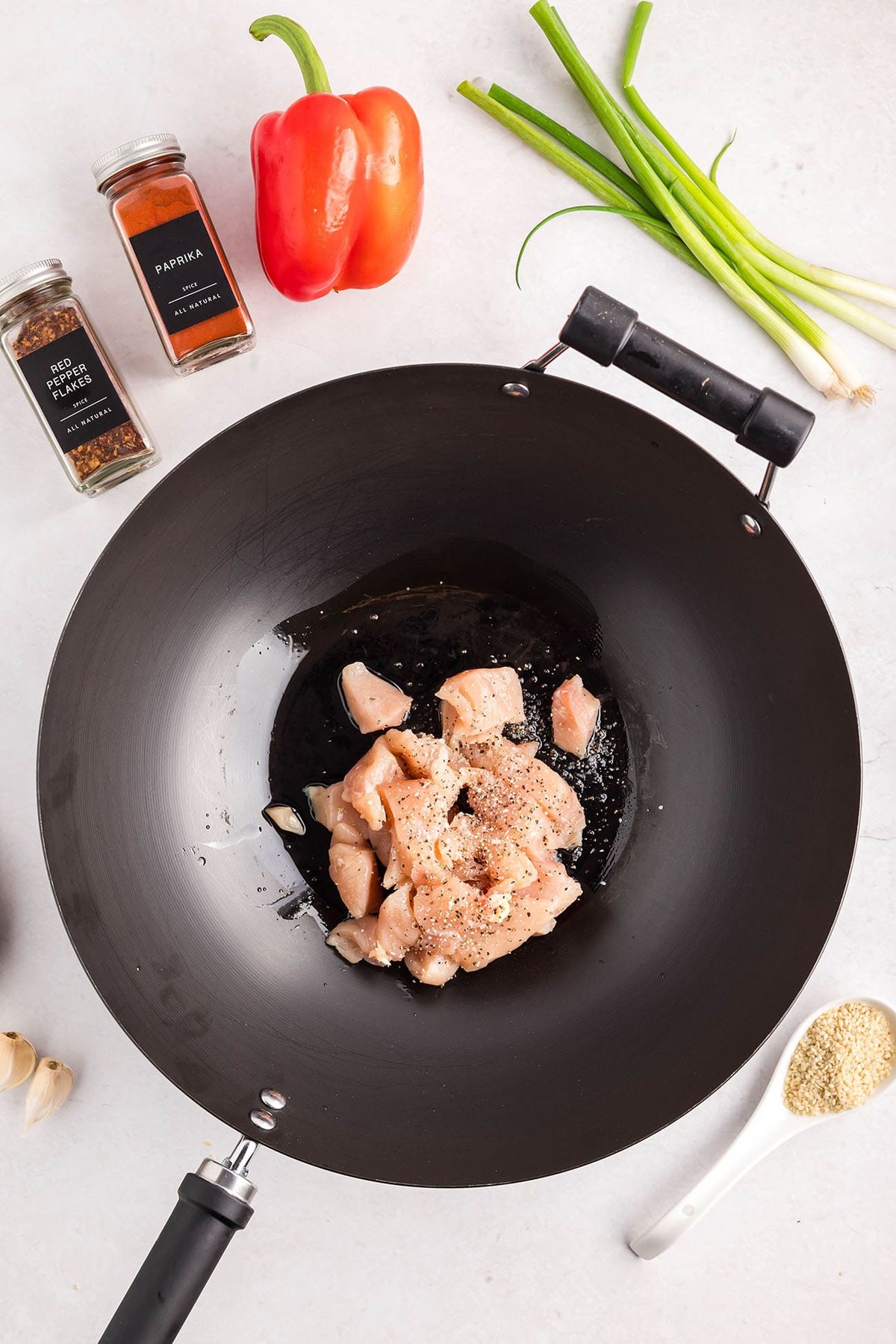 Cashew Chicken Stir Fry cooking in a wok with chicken, broccoli, red peppers, and cashews — step-by-step process from start to finish.