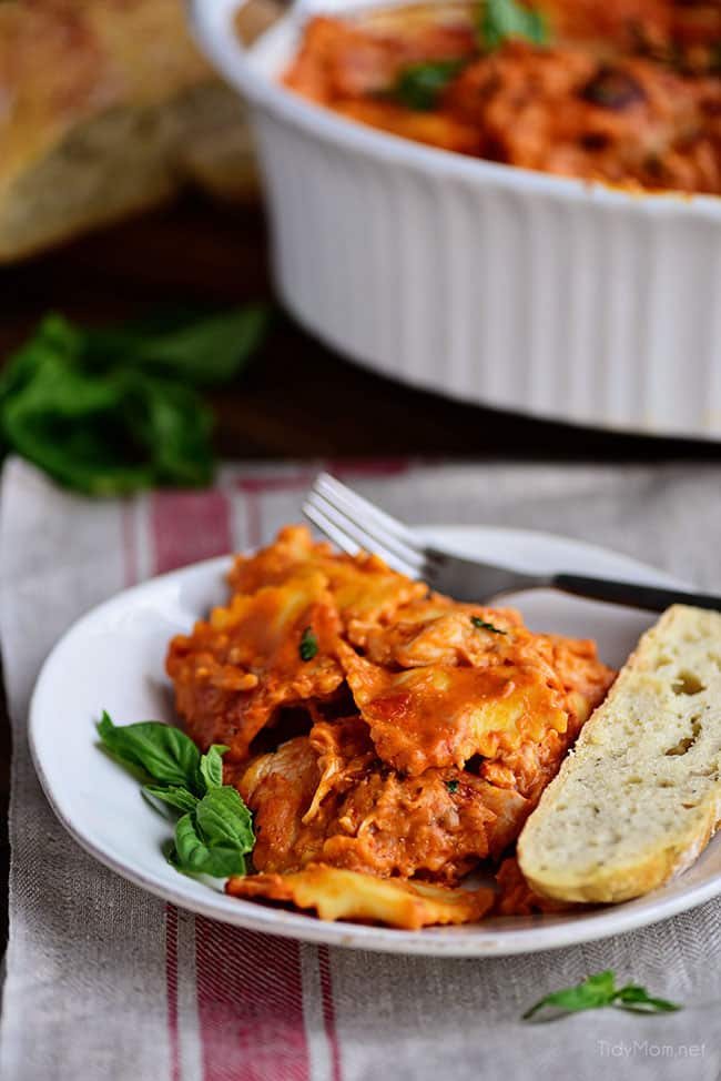 Cheesy Ravioli Bake Casserole with Chicken is easy to make and impossible to resist. Making it the perfect weeknight dish. Cheese ravioli, marinara sauce, chicken and lots of cheese, all layered and baked until bubbly and gooey! Print recipe + view short recipe video at cetcu.com