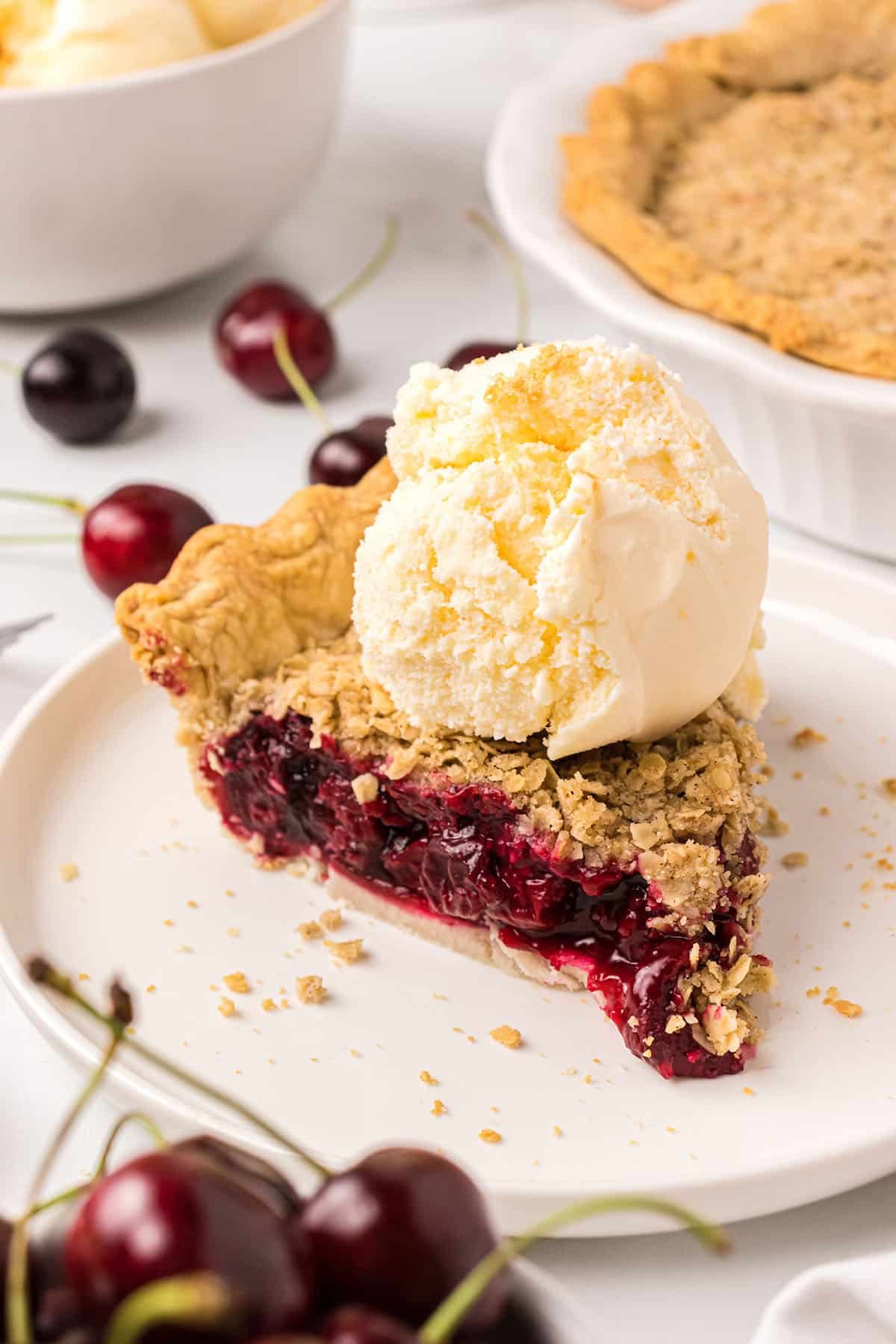 Cherry pie slice with vanilla ice cream on top