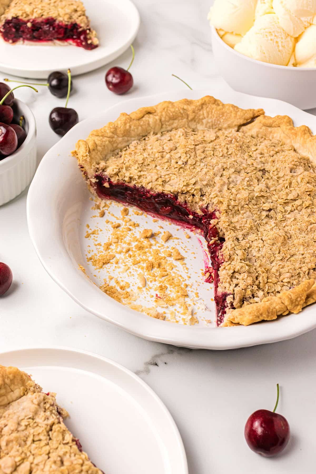 cut Cherry Crumb Pie in a white pie dish