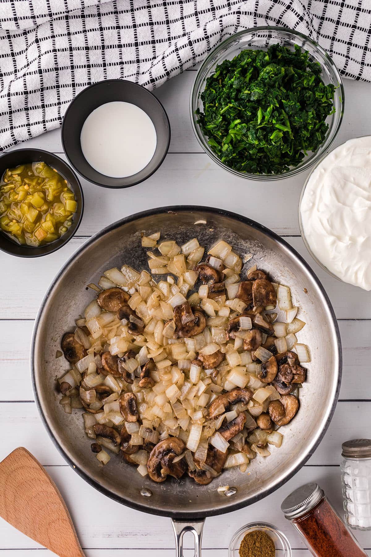 sautéing mushrooms and onions in a skillet with butter