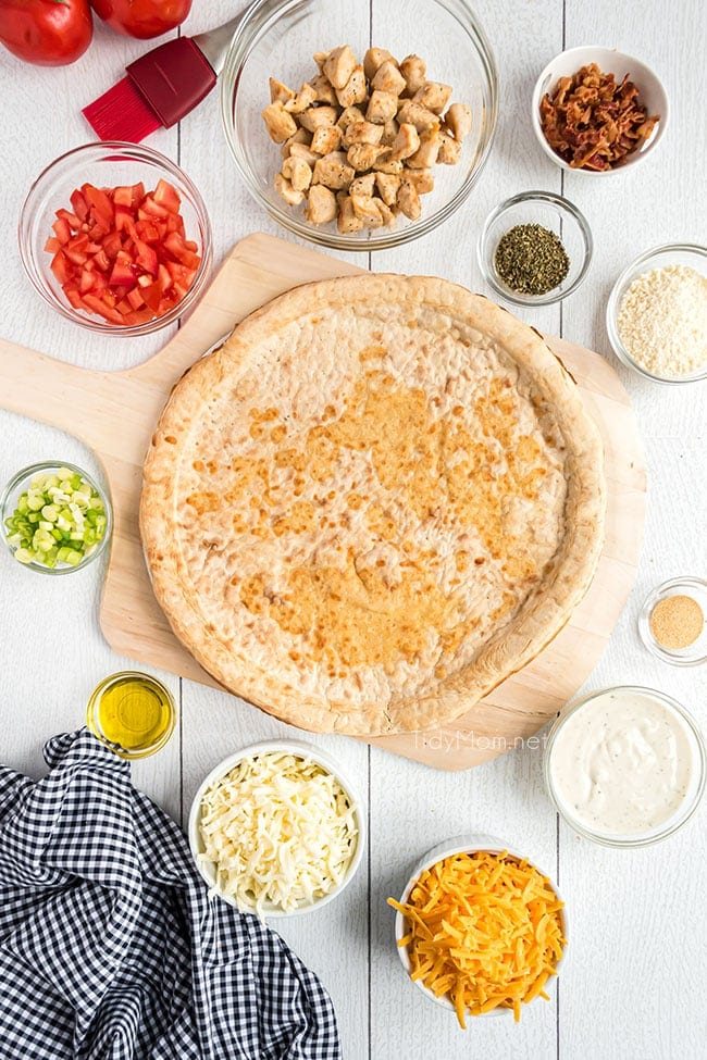 ingredients for chicken bacon ranch pizza on a counter