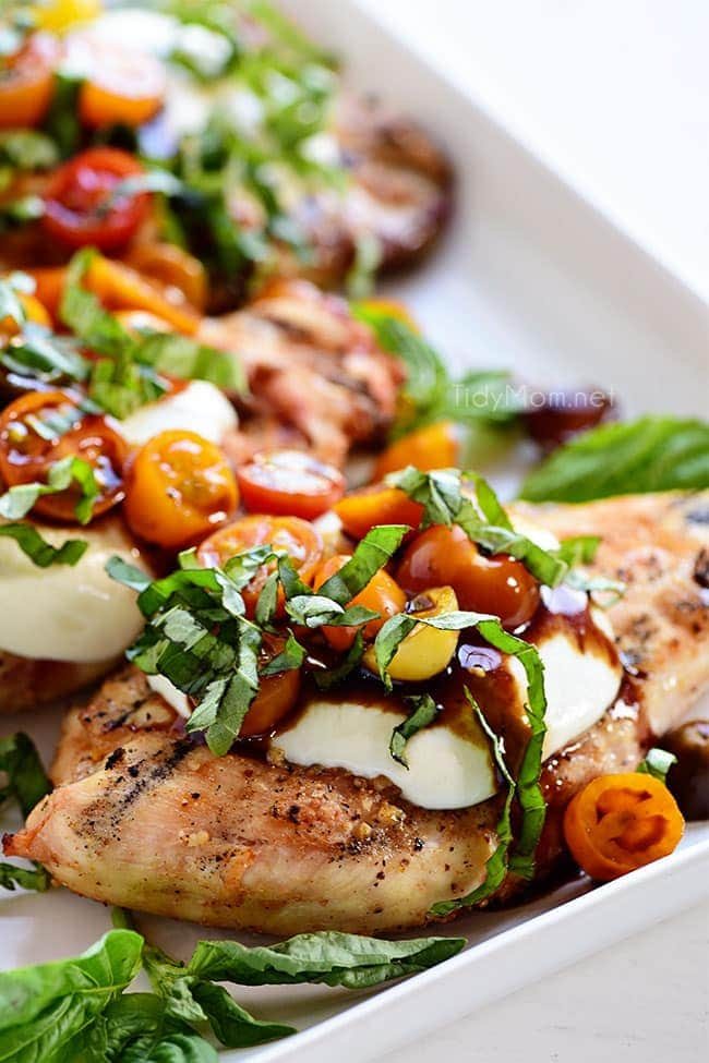 grilled chicken breasts topped with mozzarella, tomatoes and basil