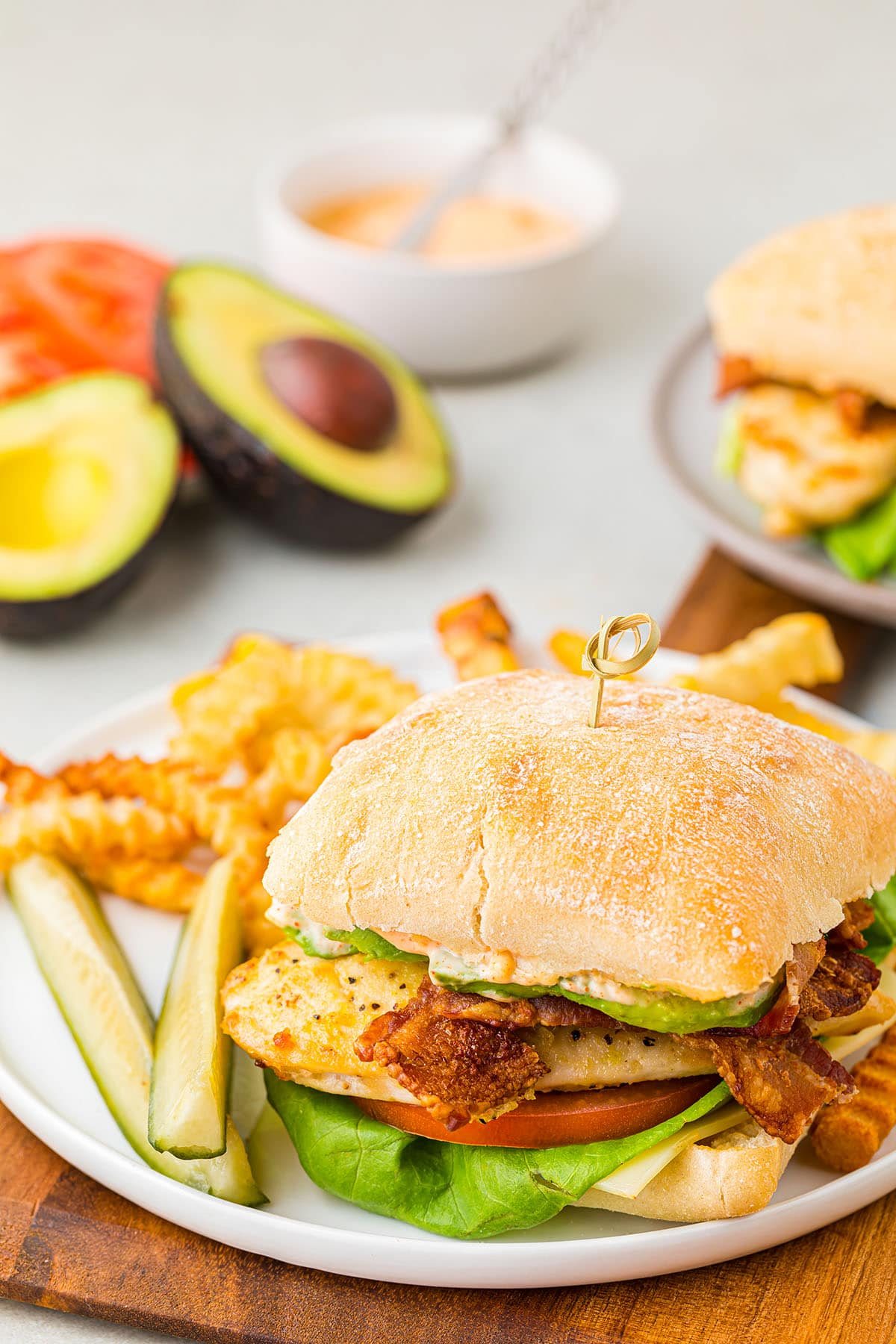 chicken sandwich on a plate with fries