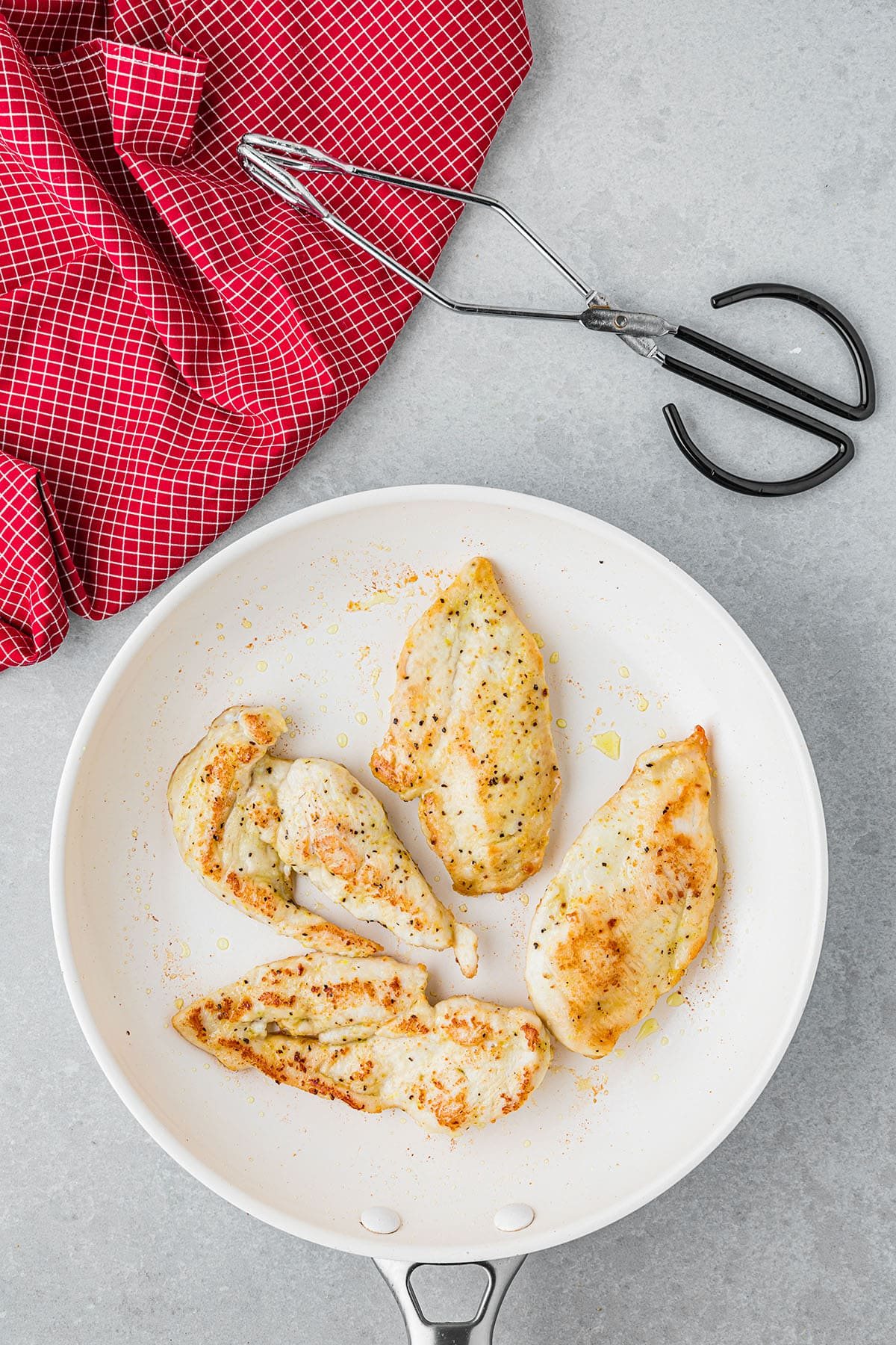 seasoned chicken breasts in a skillet