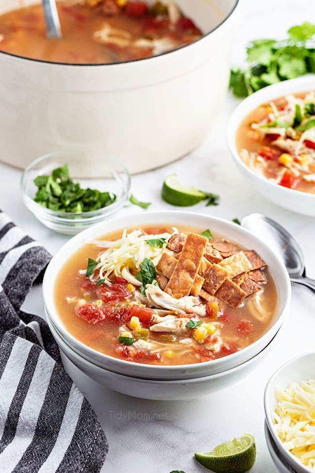 bowls of soup next to a white pot of soup