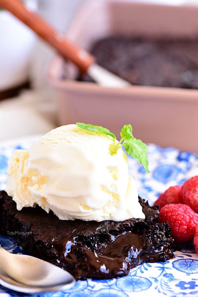 chocolate lava cake on a plate topped with ice cream