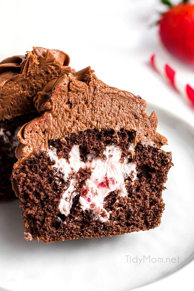 a strawberry filled cupcake cut in half so you can see the creamy filling