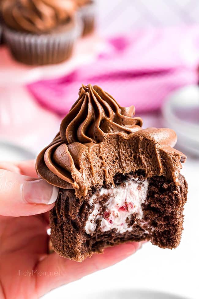 bite out of chocolate cupcake with creamy filling